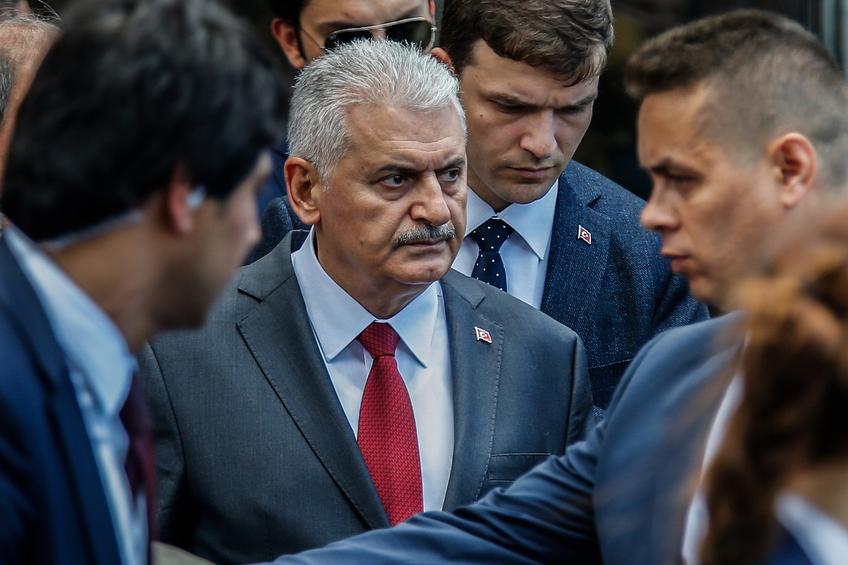 Turkey's Prime Minister Binali Yildirim walks near the site of Tuesday explosion in Istanbul, Wednesday, June 8, 2016. The bomb attack that targeted a bus carrying riot police during rush hour traffic in Istanbul killed a number of people and wounded dozens of others. It marks the fourth bombing to hit the Turkish city this year and there was no immediate responsibility claim but Turkey has witnessed an increase in violence linked to Kurdish rebels and Islamic State militants.(AP Photo/Emrah Gurel)