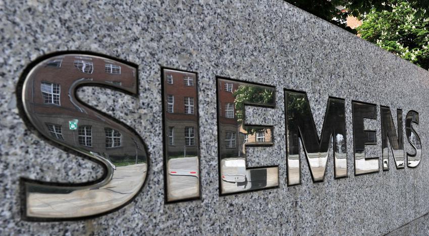 epa05021851 (FILE) A file photo dated 07 March 2015 showing parts of Siemens administration building reflected in the lettering 'Siemens' in Berlin, Germany. Shares in German industrial giant Siemens jumped more than 2 per cent on 12 November 2015 after it launched a 3-billion-euro (3.2-billion-dollar) share-buyback programme and set out a positive business outlook for 2016. Fourth-quarter profit from Siemens' industrial businesses - which analysts see as a key measure of the group's performance - rose 9 per cent to 2.5 billion euros compared with 2.25 billion in the same period last year, said the company, whose fiscal year runs to the end of September. The quarterly rise in earnings was despite the economic slowdown under way in the company's key markets in emerging economies, notably China.  EPA/PAUL ZINKEN