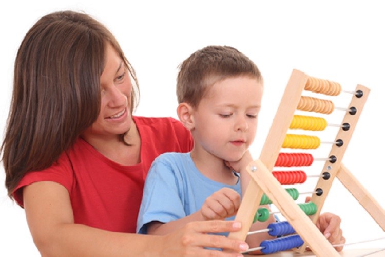 mother and 5-6 years old boy with big abacus isolated on white