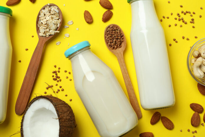 Concept,Of,Vegan,Milk,On,Yellow,Background,,Top,View