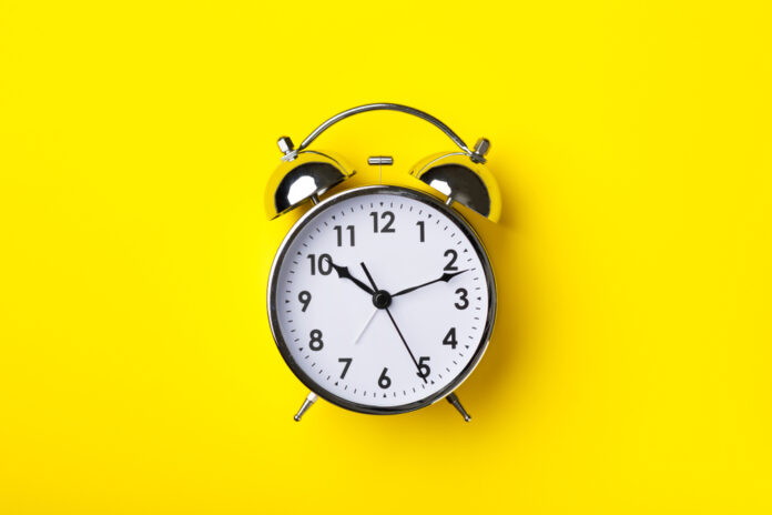 Retro,Alarm,Clock,On,Bright,Yellow,Background