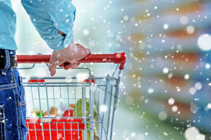 Young,Man,With,Shopping,Cart,In,Store,Over,Snow,Effect