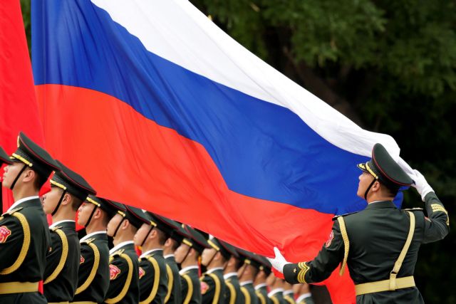 FILE PHOTO: An honour guard holds a Russia flag during preparations for a welcome ceremony for Russian President Vladimir Putin outside the Great Hall of the People in Beijing, China