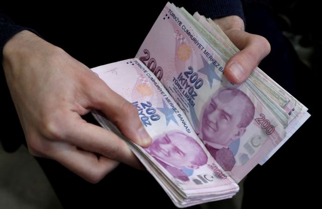 FILE PHOTO: A merchant counts Turkish lira banknotes at the Grand Bazaar in Istanbul